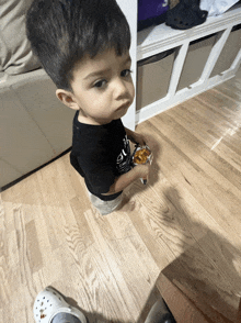 a little boy wearing a black shirt that says " i 'm a cat "