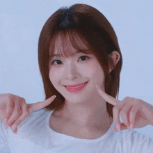 a young woman making a face with her hands