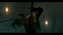 a predator is holding a large spear in his hand
