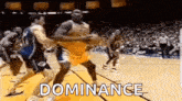 a group of basketball players are playing a game of basketball on a court and the word dominance is written on the screen .