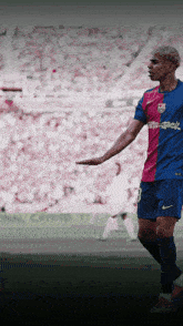 a soccer player with the number 8 on his jersey stands on a field