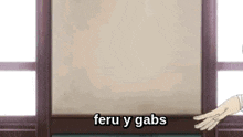 a person is standing in front of a window with the words feru y gabs on it .