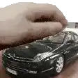 a hand is reaching out towards a model car .