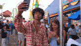 a man is taking a picture of himself with his phone while a woman looks at her phone