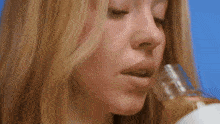 a close up of a woman 's face with her eyes closed