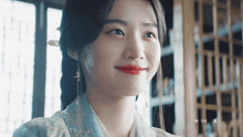 a close up of a woman 's face with chinese writing in the background