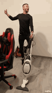 a man is standing next to a vacuum cleaner with a chair in the background and a gif that says imgplay