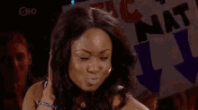 a woman is making a funny face in front of a sign that says lynx .