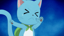 a blue cat with a green scarf around its neck is making a funny face