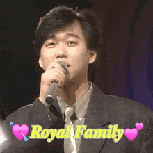 a man singing into a microphone with the words royal family written above him