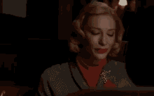 a woman is sitting in a chair and saying `` i 'm starved '' while looking at a tablet .