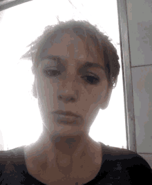a close up of a woman 's face with a very serious look on her face