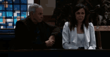 a man and a woman are sitting next to each other in a church