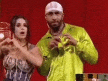 a man and a woman are dancing together on a stage .