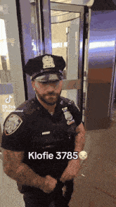 a police officer is standing in front of a door and has the number 3785 on his chest