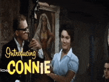a man playing a double bass next to a woman with the words introducing connie above them