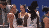 a group of female basketball players one of whom is wearing a number 8 jersey