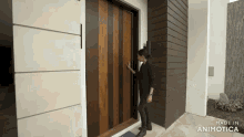 a woman is standing in front of a wooden door that says made in animatica