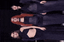 three women are standing next to each other wearing dresses