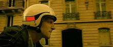 a man wearing a white helmet with a red stripe on it