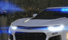 a police officer standing next to a white car with blue lights