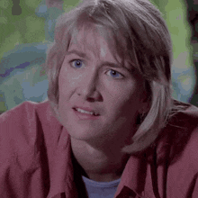 a close up of a woman 's face with a surprised look on her face .