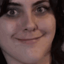 a close up of a woman making a funny face .