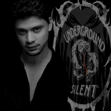 a man is standing in front of a shirt that says " underground silent "