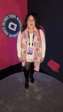 a woman stands in front of a sign that says " studio dewey "