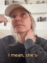 a woman wearing a hat and a sweater says i mean she 's