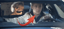 a man wearing headphones and sunglasses is driving a car with a red arrow pointing up