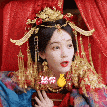 a woman wearing a red and blue dress and a gold crown