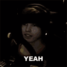 a man wearing headphones is making a funny face and says yeah