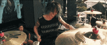 a man playing a drum set with a cymbal that says sabian on it