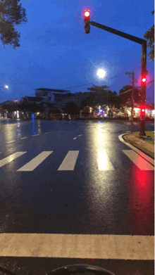 a busy intersection with a red light at the top