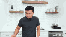 a man standing in a kitchen with the words made in animatica on the bottom left