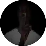 a woman is holding her finger to her mouth in a circle .
