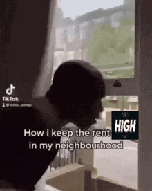 a man is standing in front of a window and talking about how i keep the rent in my neighborhood .