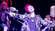 a man with red hair is wearing a purple shirt and a purple jacket