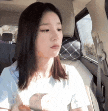 a woman sitting in the back seat of a car