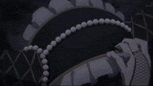 a person wearing a black hat with white pearls