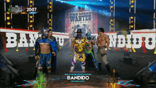 a group of wrestlers are standing in front of a wanted poster