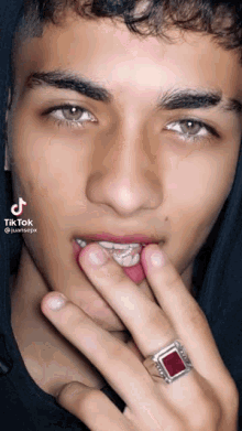a close up of a person 's face with a tik tok watermark
