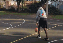 a man playing basketball with a hoodie that says ' simpson ' on it