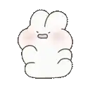 a white rabbit with a pink cheek is sitting on a white surface .