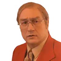 a man wearing glasses and a red suit makes a surprised face
