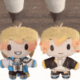two stuffed dolls are standing next to each other and one of them has a hoodie on