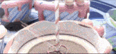 a pink and white striped candy cane sticks out of a bowl