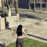 a video game character named madeline rhodes is standing on the sidewalk
