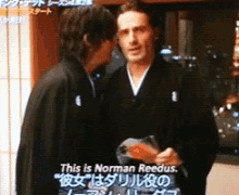 two men are standing next to each other and a caption says this is norman reedus